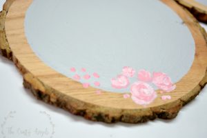 painting rose flowers on wood slice